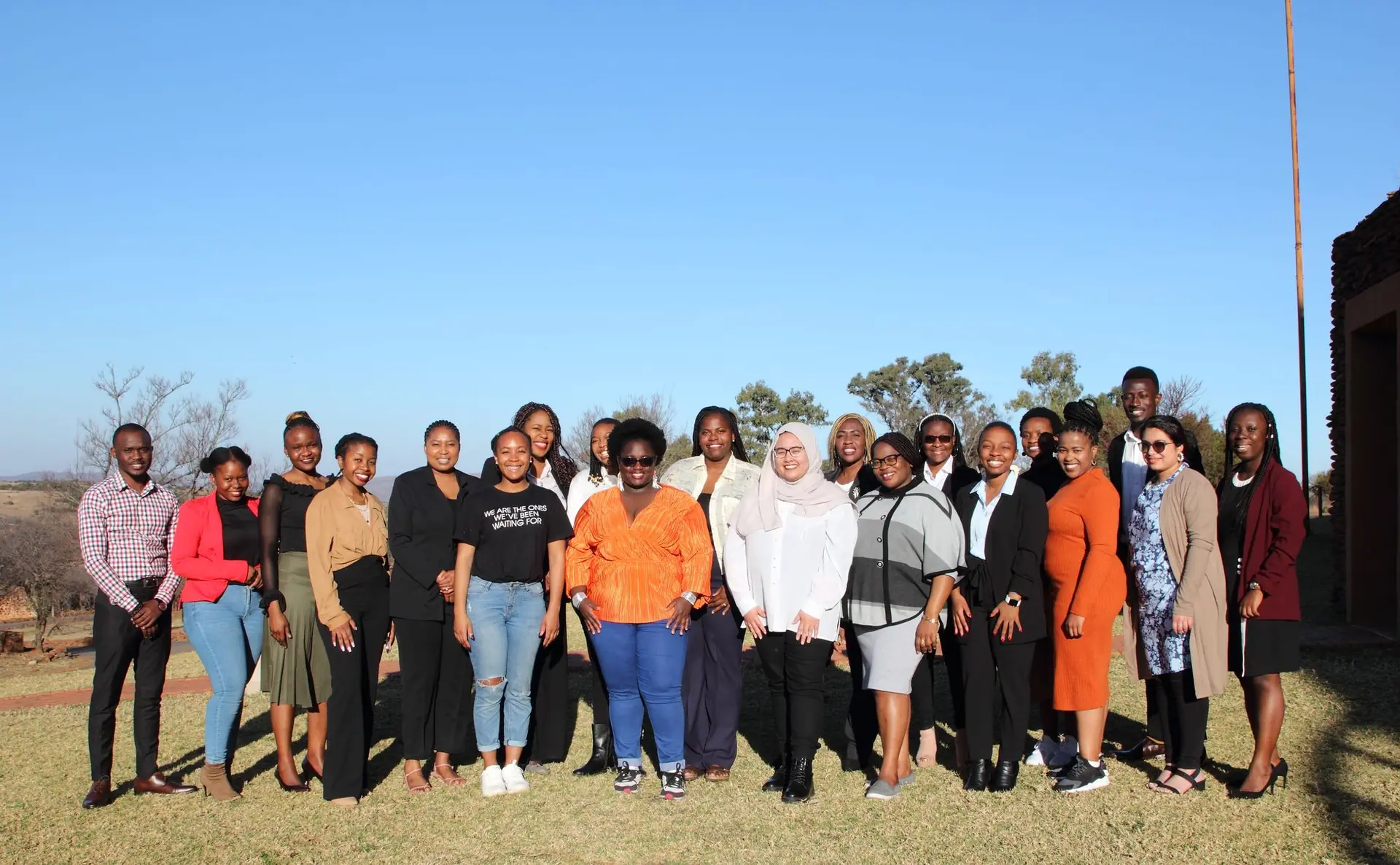 Cohort group photo in an open field