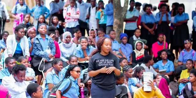 Crowd of learners in uniform at a school assembly