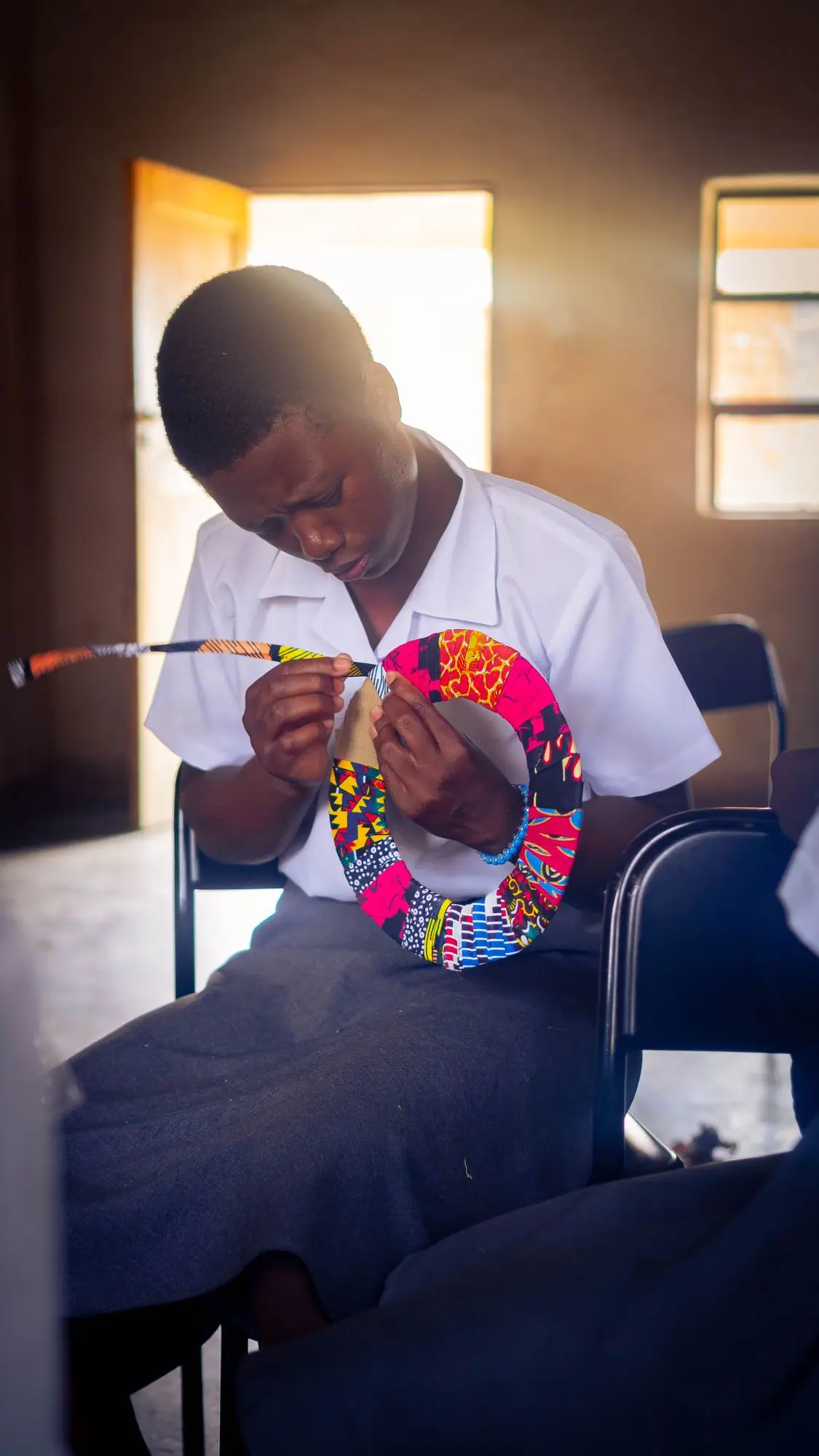 Learner sewing a colourful reusable pad