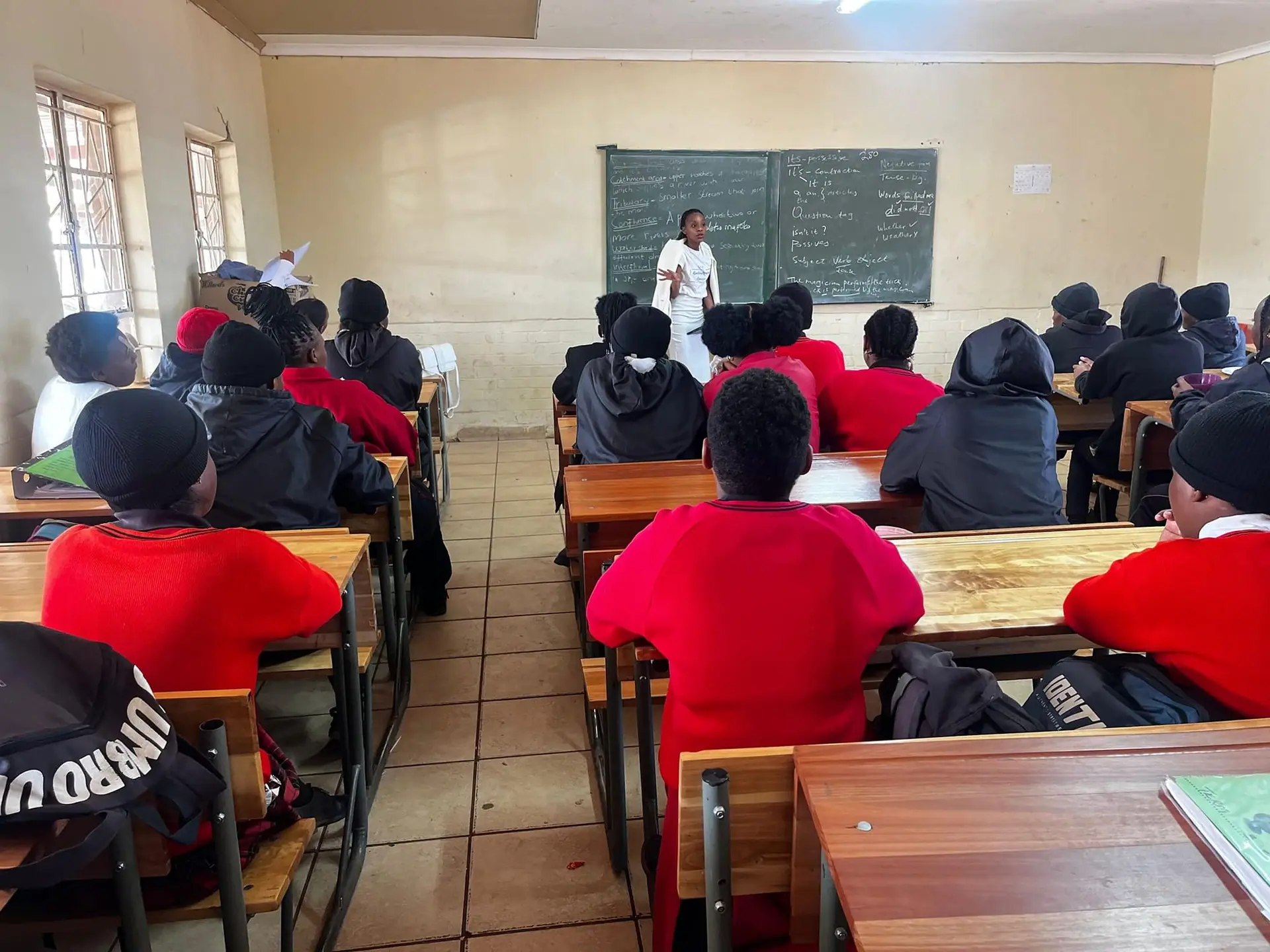 Learners in a classroom listening to a presentation