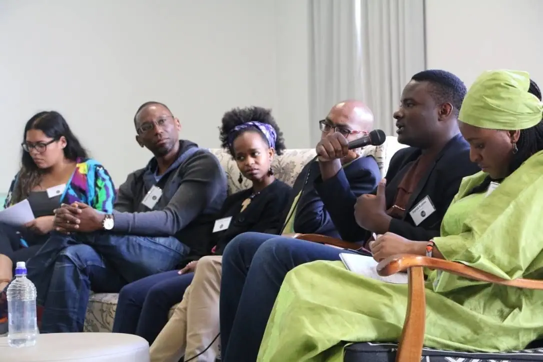 Panel discussion with speakers seated at the front of a room