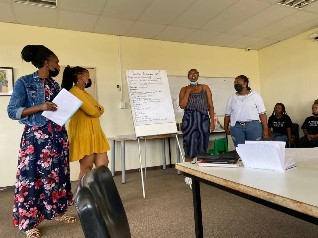 Participant presenting to the group at a flip chart