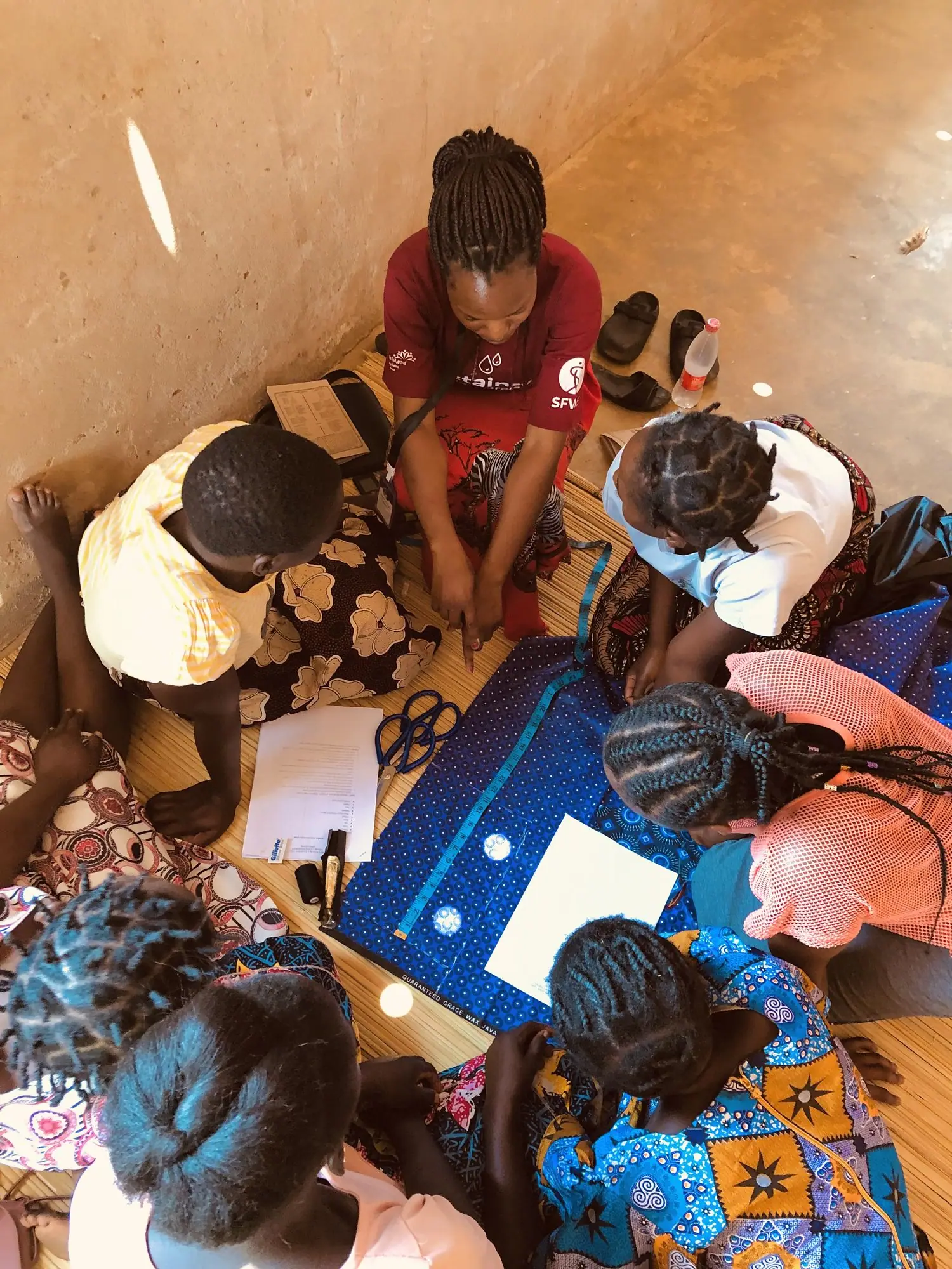 Participants cutting fabric for reusable pads
