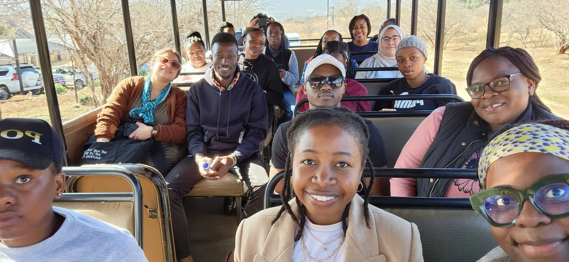 Participants on a game-drive vehicle during a retreat
