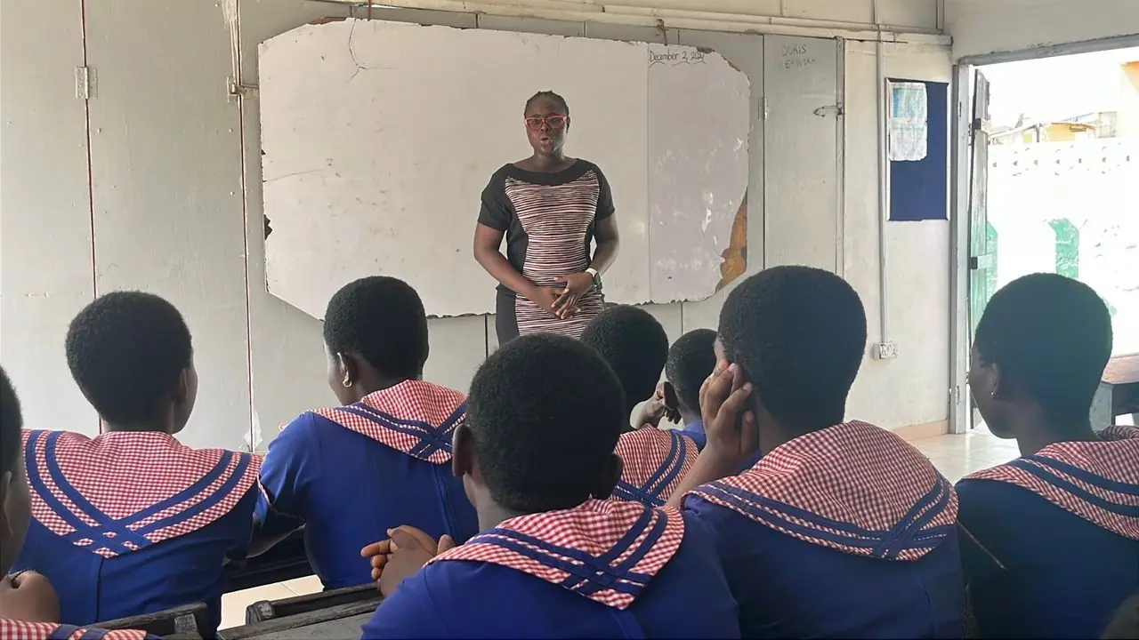 Speaker addressing learners in a classroom
