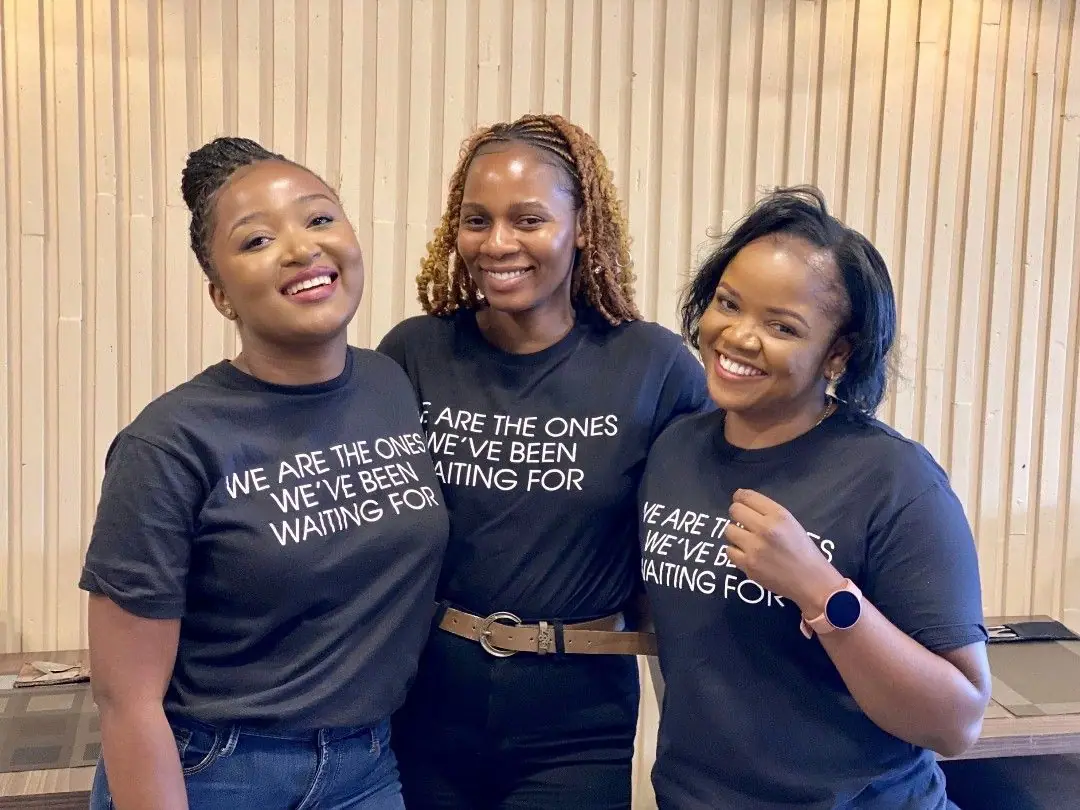 Three women in We are the ones we've been waiting for T-shirts