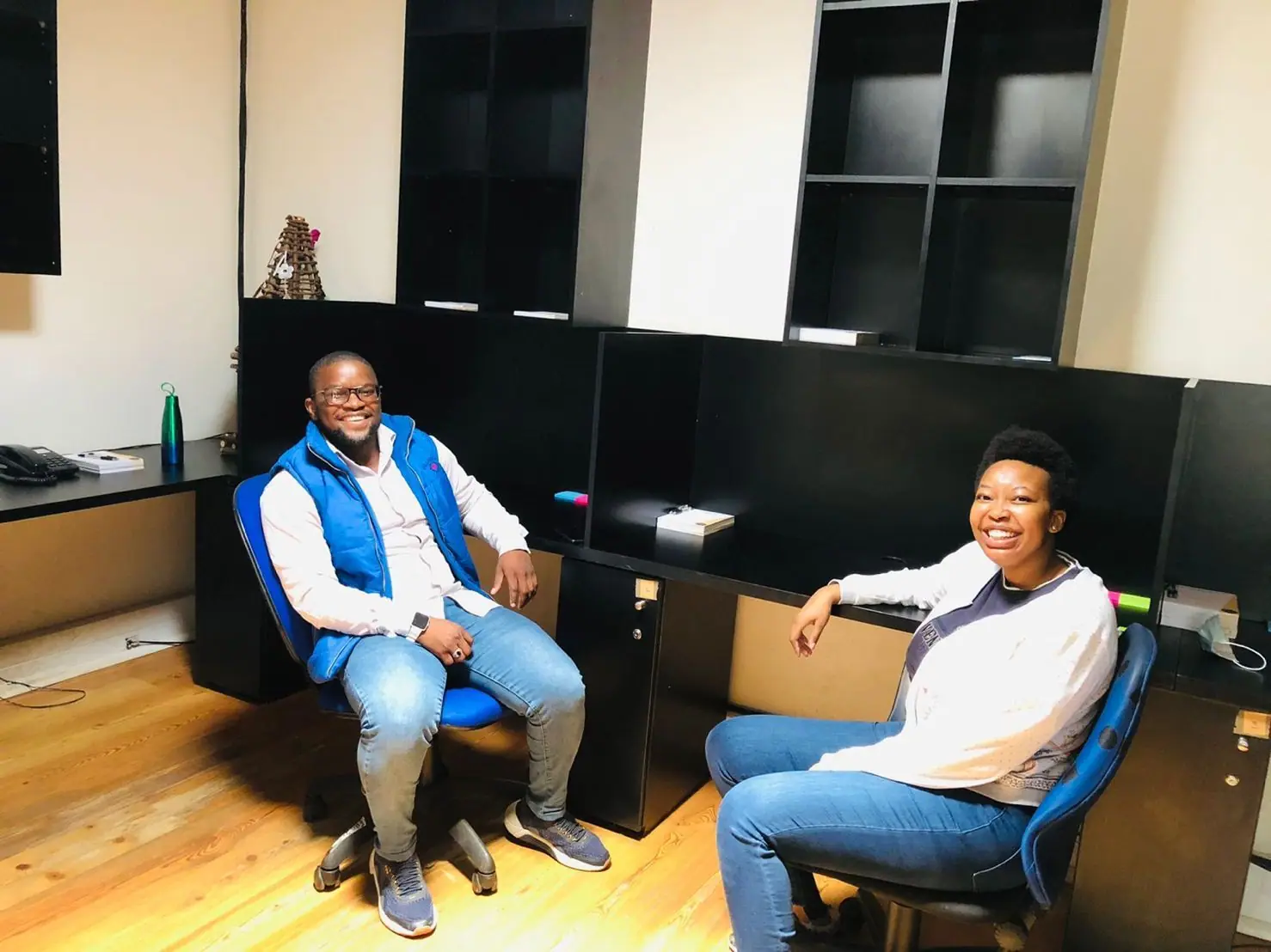 Two team members in conversation in an office